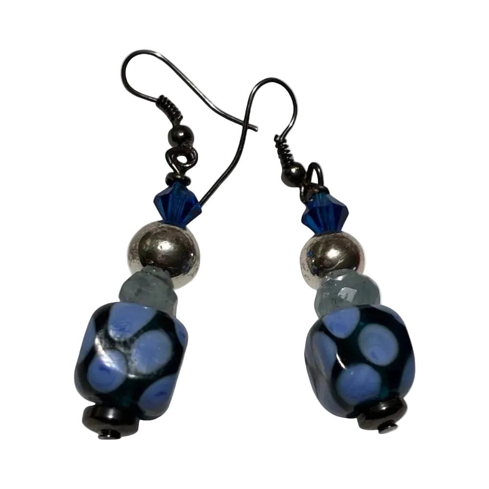 Pair of earrings with blue and black beads on a white background